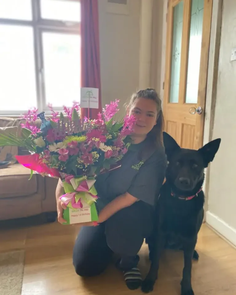 Jordan with her black dog during a training session
